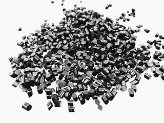 Close-up of black plastic polymer granules on white background