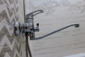 Elegant faucet shower tap in a bright bathroom