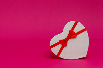 Three heart-shaped boxes on a pink background. Decor for Valentine's Day celebration