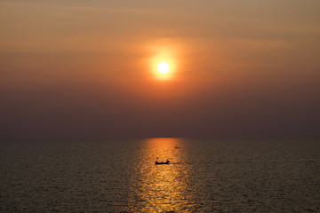 the sun falls Thai sea and fishing tiny boat ,