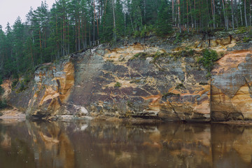 City Cesis, Latvia. Red rocks and river Gauja. Nature  and green trees in winter.