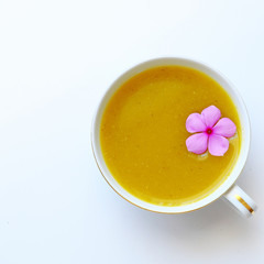 cup of winter squash milk on white