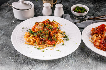 Italian pasta, spaghetti with meat balls with tomato sauce and herbs. Traditional Mediterranean Cuisine