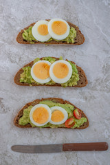 sliced avocado and egg on toasted bread 