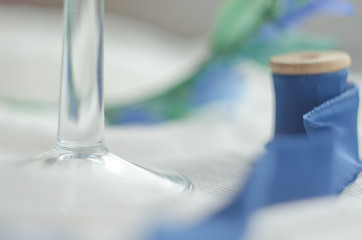 Wedding blue decor with silk ribbon, bride wreath and crystals. Copy space. Soft focus