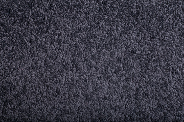Fototapeta premium Carpet covering background. Pattern and texture of black colour carpet. Copy space.