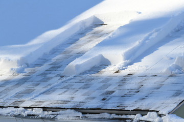 snow removal on the roof after snow storm © nd700