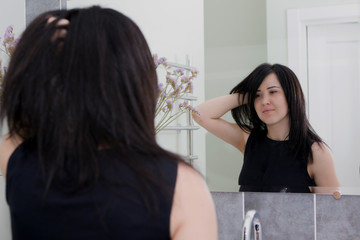 Sexy young woman. Seductive young woman with long hair posing in the bathroom.