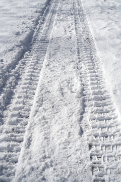 tire tracks in the snow at the parking area