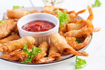 Shrimps with ginger in filo pastry with sweet and sour sauce. Thai cuisine. Deep-fried prawns.