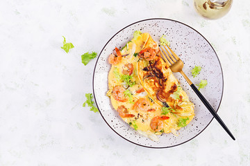 Breakfast. Ketogenic/paleo diet. Omelet with shrimp and herbs. Keto menu. Omelette. Top view, overhead