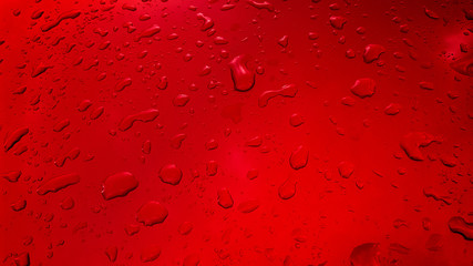 Water Drops background on the red glossy surface, Rain droplets on red texture