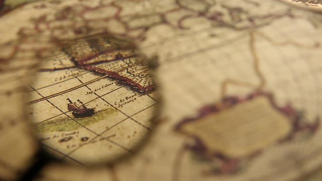 Close up of an old vintage map with magnifying lens 