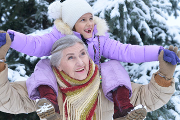 Portrait of grandmother and granddaughter in winter