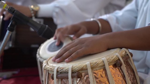 Man Playing Indian Traditional Musical Instrument Tabla In Gurudwara, Close-Up Slow Motion Slide Shot.