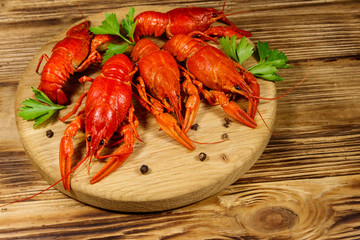 Boiled crayfish on cutting board on wooden table