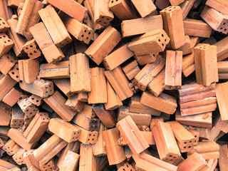 Pile of red bricks for construction. Brick block texture.