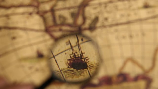 Close up of an old vintage map with magnifying lens 