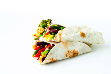 Mexican tortilla with vegetable and mushroom fillings on white background. Healthy eating concept. Budget-friendly menu.Close-up