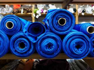 Blue rolls of knitted fabric. Classic blue color