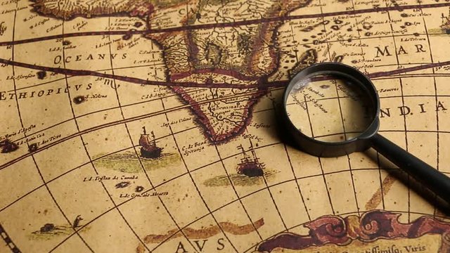 Close up of an old vintage map with magnifying lens 