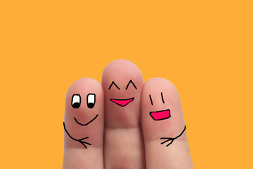 three best friends hands fingers of man and woman on yellow background
