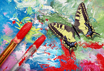 artist’s brushes and palette. colorful butterfly and brushes. color concept in art. 