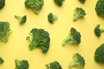 Fresh tasty broccoli on yellow background, flat lay