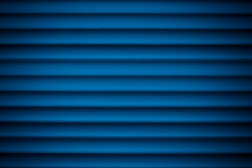 Obraz premium Dark blue metallic striped surface. Metal wall siding. Striated fence with shine. Convex wall texture. Ribbed surface of metal jalousie, door. Abstract pattern from lines.