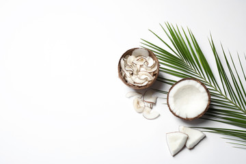 Composition with tasty coconut chips on white background, top view