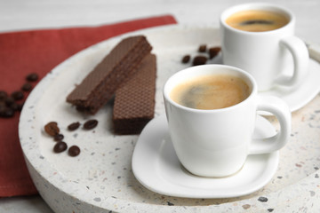 Delicious coffee and wafers for breakfast on tray, closeup. Space for text