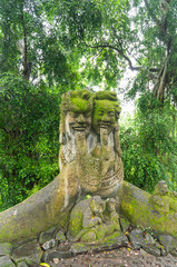 Fototapeta na wymiar A stone statue in the sacred monkey forest. Ubud, Bali, Indonesia