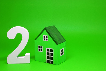 Fototapeta na wymiar Two ( 2 ) House Isolated Green Background with Copy Space - Second hand home or Used house Business building finance Concept