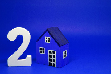 Fototapeta na wymiar Two ( 2 ) House Isolated Blue Background with Copy Space - Second hand home or Used house Business building finance Concept