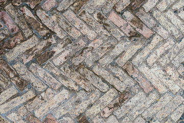 Old brick floor made of bricks of different sizes in the antique Italian city of Antica Ostia