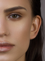 Fototapeta premium Half Beauty Woman Portrait. Professional Makeup for Brunette with brown eyes - natural Lipstick, Smoky Eyes. Beautiful Fashion Model Girl. Perfect Skin. Make up. Bruten hair