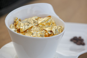 24 carat gold coffee. A cup of coffee sprinkled with 24 carat gold flakes