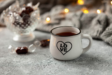 Valentine day concept. White cup of tea with love inscription