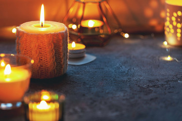 Candles and a garland on a windowsill, scandinavian interior style. Bokeh lights. Cozy place. Hygge concept.