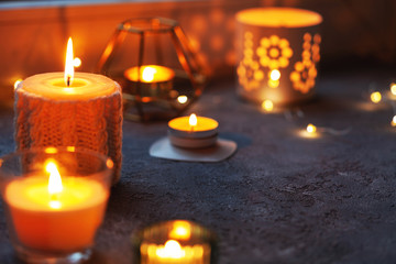 Candles on windowsill. Hygge style, bokeh, close-up