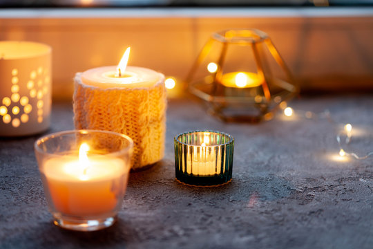 Candles on windowsill. Bokeh. Hygge concept. 