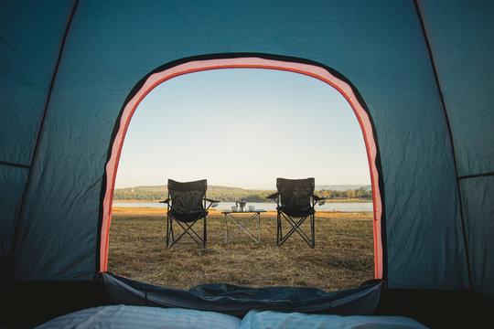 View From Inside Tent, Outdoor Two Empty Chairs With Picnic Table And Moka Pot Coffee For Camping.