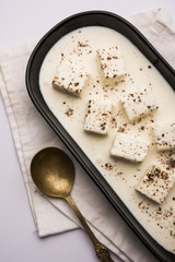Paneer Dum Kali Mirch / Kalimirch, prepared in a white creamy gravy and black pepper powder sprinkled over it. served in a bowl. Selective focus