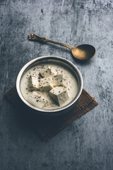 Paneer Dum Kali Mirch / Kalimirch, prepared in a white creamy gravy and black pepper powder sprinkled over it. served in a bowl. Selective focus