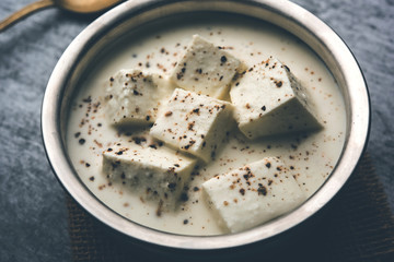 Paneer Dum Kali Mirch / Kalimirch, prepared in a white creamy gravy and black pepper powder sprinkled over it. served in a bowl. Selective focus