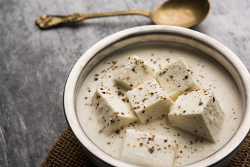 Paneer Dum Kali Mirch / Kalimirch, prepared in a white creamy gravy and black pepper powder sprinkled over it. served in a bowl. Selective focus