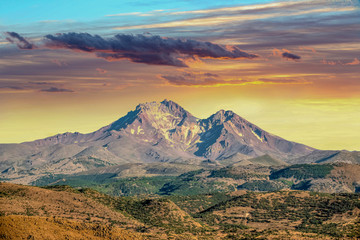 a mountain and sky at sunset