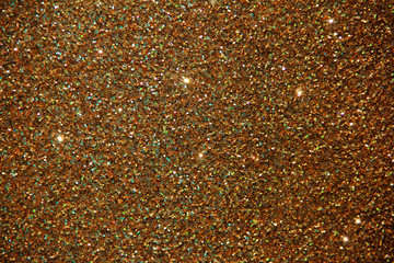 texture of golden shiny fabric with small sparkles