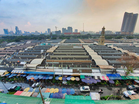 Top view of the famous Jatujak or Chatuchak weekend Sunday market, The view of hundreds stall roof and clock tower, wide-angle lenses, main meeting point in Bangkok, Thailand.