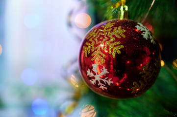 Fototapeta premium New Year and Christmas concept. Festive photo of decorations for the Christmas tree in the New Year holiday on a background of lights